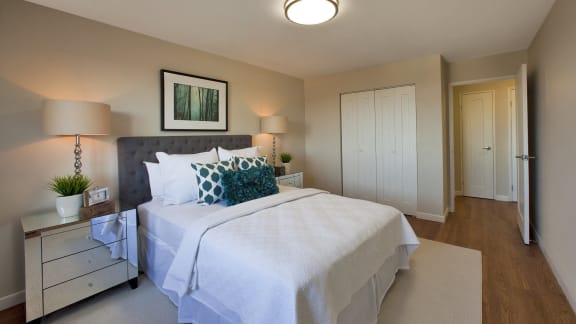 a bedroom with a large bed and a dresser