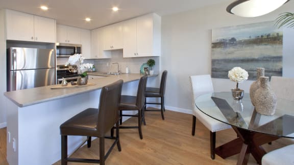 a kitchen and dining room with a table and chairs