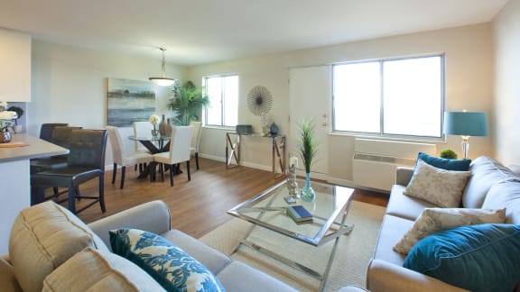 a living room and dining room with a couch and a table
