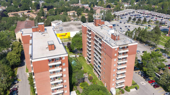 an aerial view of an apartment building and a parking lot