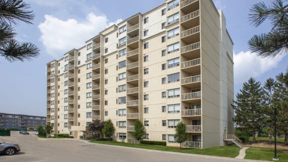 a large apartment building with many balconies on the side of a street
