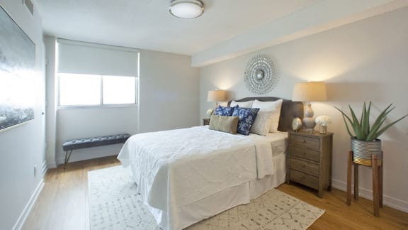 a bedroom with a bed and a window