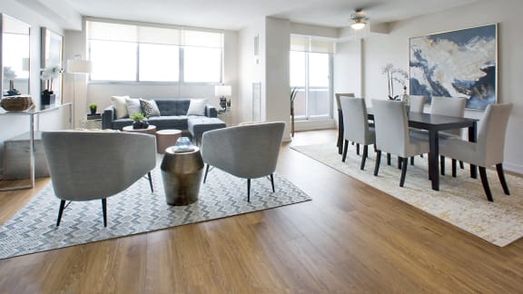 a living room and dining room with a table and chairs