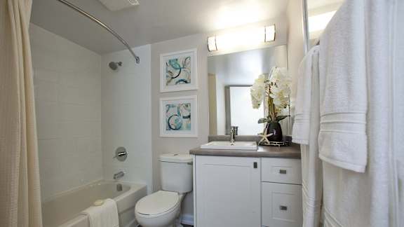a white bathroom with a toilet sink and tub