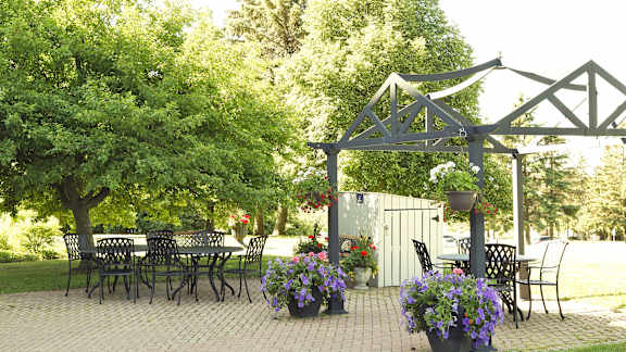 a patio with a table and chairs and a gazebo