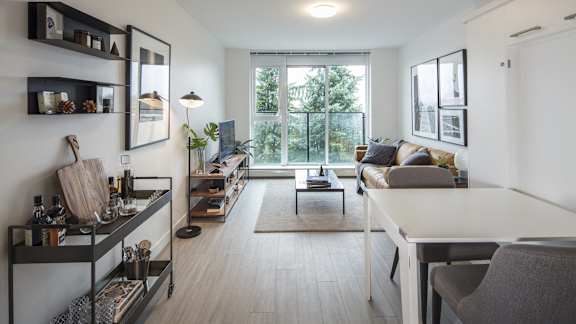 A modern kitchen with a dining area and a living room.