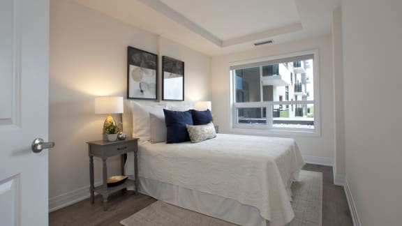 a bedroom with a large bed and a window