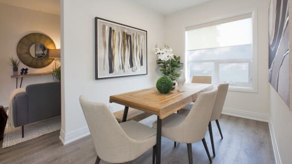 an image of a dining room with a table and chairs