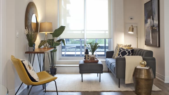 a living room with a couch and a window