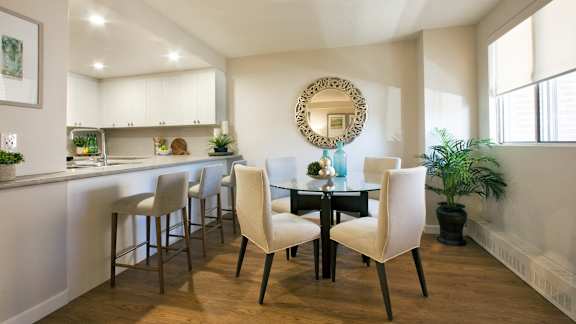 a dining room and kitchen with a table and chairs