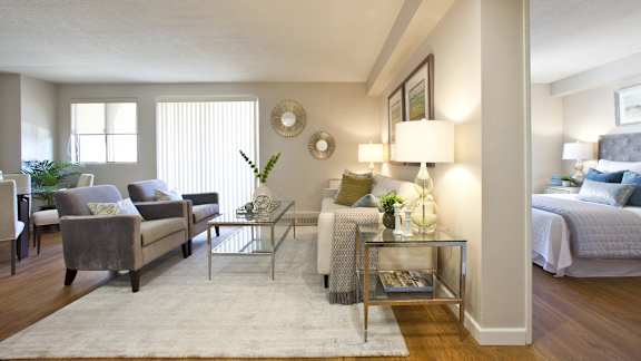 a living room with a couch and a chair and a table