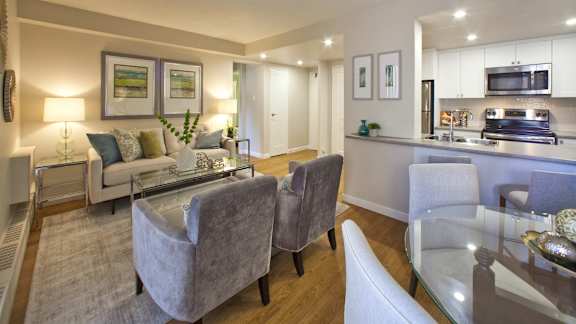 a living room and kitchen with a table and chairs