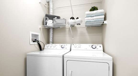 A white washing machine and dryer in a laundry room.