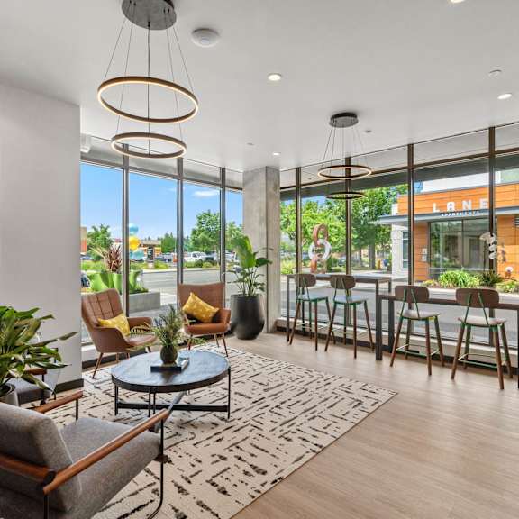 A modern living room with a glass door leading to a balcony.