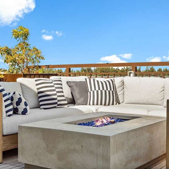 A modern outdoor seating area with a fire pit.