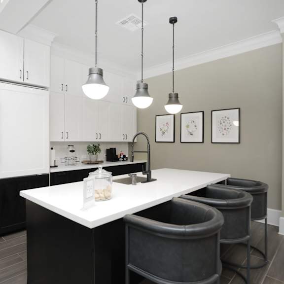 a kitchen with a large island with bar stools at Madison on the Meadow in TX 77477