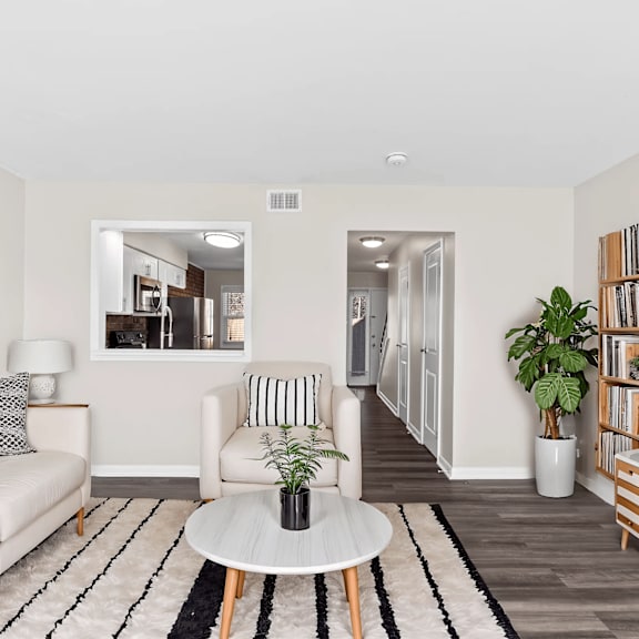 A living room with a white couch and a coffee table.