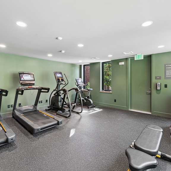 A gym with treadmills and exercise bikes.
