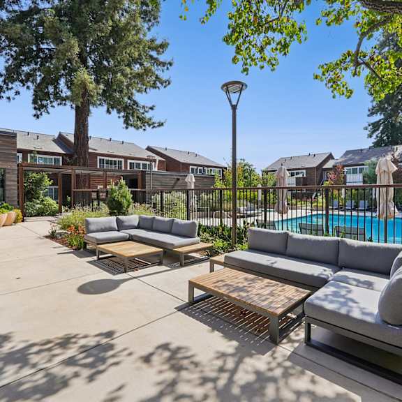 Anton Pacific patio with a table and chairs in front of an apartment building in Santa Cruz