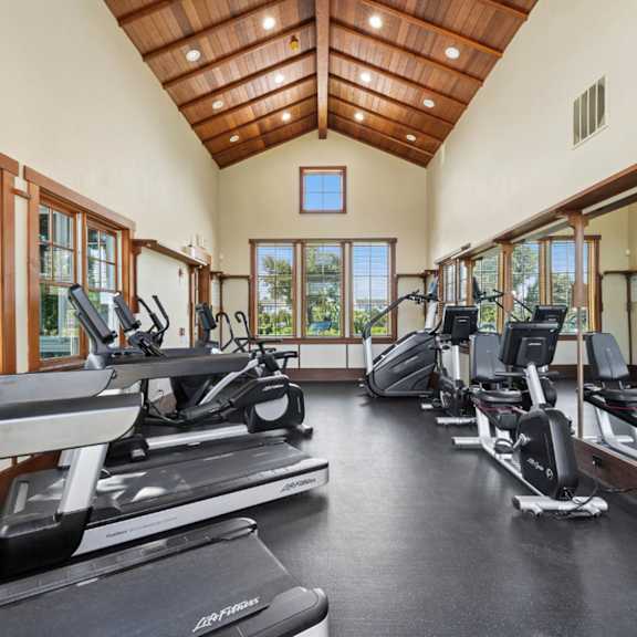 A gym with treadmills and exercise bikes.