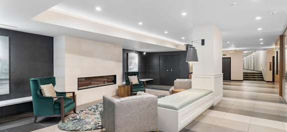 a living room with a couch and chairs and a fireplace