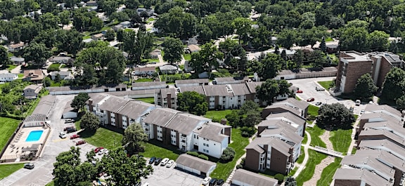 A large brick building with a green lawn in front.