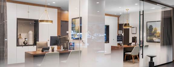 the kitchen and living room are separated by a glass wall