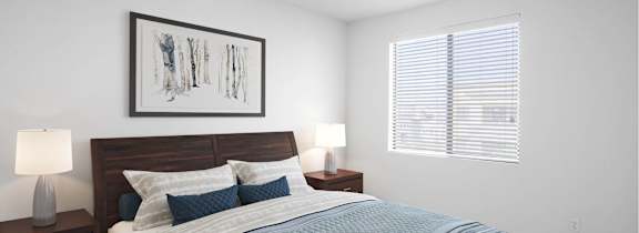 A bedroom with a bed, nightstands, and a ceiling fan.