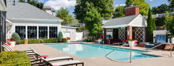 a swimming pool with lounge chairs next to a resort style pool at Residences at Stevens Pond, Saugus