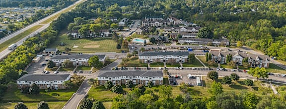 A bird's eye view of a residential area with houses and cars.