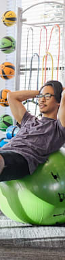 people working out on exercise balls in a gym at Century Mundy Mill Apartments, Georgia 30566