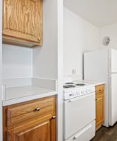 A kitchen with a white stove and white refrigerator at Independence Place Apartments, Parma Heights, OH 44130