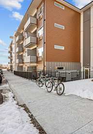 Apartment building with a bicycle parked in front.