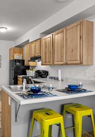 A kitchen with a washer and dryer built in to the cabinetry.