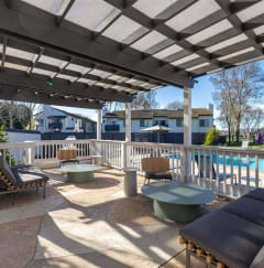 a patio with a pool and chairs and a pergola at Diablo Vista Apartments, Livermore, California, 94551
