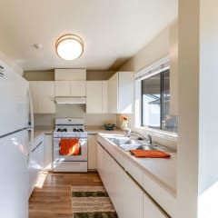 kitchen with stove, fridge, and sink