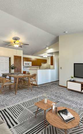 A living room with a television, a dining table, and a couch. at Somerset Apartments, Des Moines, IA, 50315