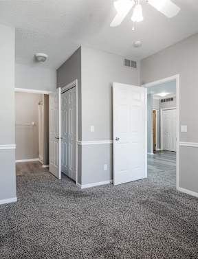 A spacious room with a ceiling fan and carpeted floor.at Diamond Brooke, West Des Moines, IA 50266