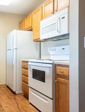 a kitchen with wood flooring and white appliances at Sunrise Meadows, Iowa, 50263
