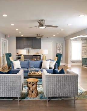 a living room with a couch and chairs in front of a kitchen at Lakeside on Riverwatch in Martinez, GA 30907