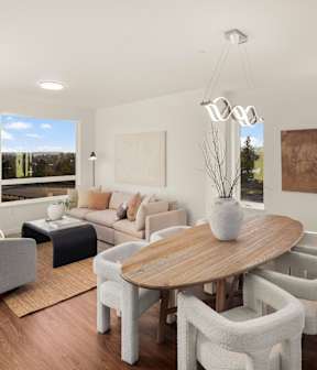 A modern living room with a large table and chairs. at The Narrows at Clare Apartments , Apartments, Bremerton, WA