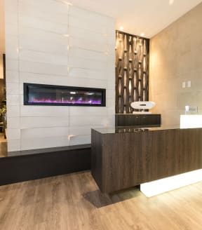the lobby of a hotel with a reception desk and a fireplace at Apartments at Denver Place, Colorado, 80202