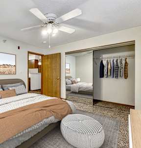 a bedroom with a bed and a ceiling fan at Somerset Apartments, Des Moines, IA, 50315