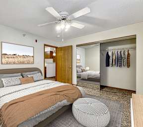A bedroom with a large bed and a ceiling fan. at Somerset Apartments, Des Moines, IA, 50315