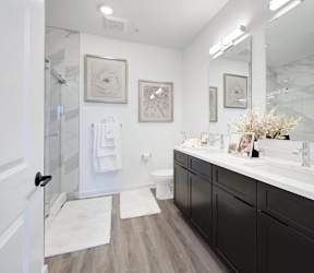 a white bathroom with a shower and sink at The Franklin at Hillsborough Apartments, Hillsborough, NJ 08844