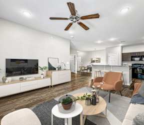 A modern living room with a white ceiling fan and a grey couch at The Barclay Apartments, Altoona, IA, 50009