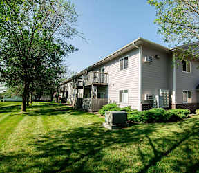 A house with a grey siding at Peach Tree Apartments, IA, 50021