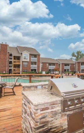the preserve at ballantyne commons outdoor deck with a grill and table with chairs