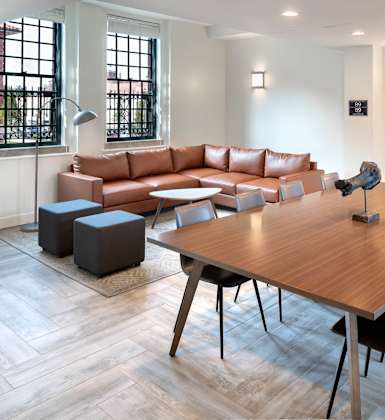 A modern living room with a wooden table and chairs.at The Residences at St. Elizabeths East, Washington, DC