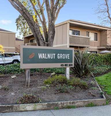 exterior of apartments with Walnut Grove sign